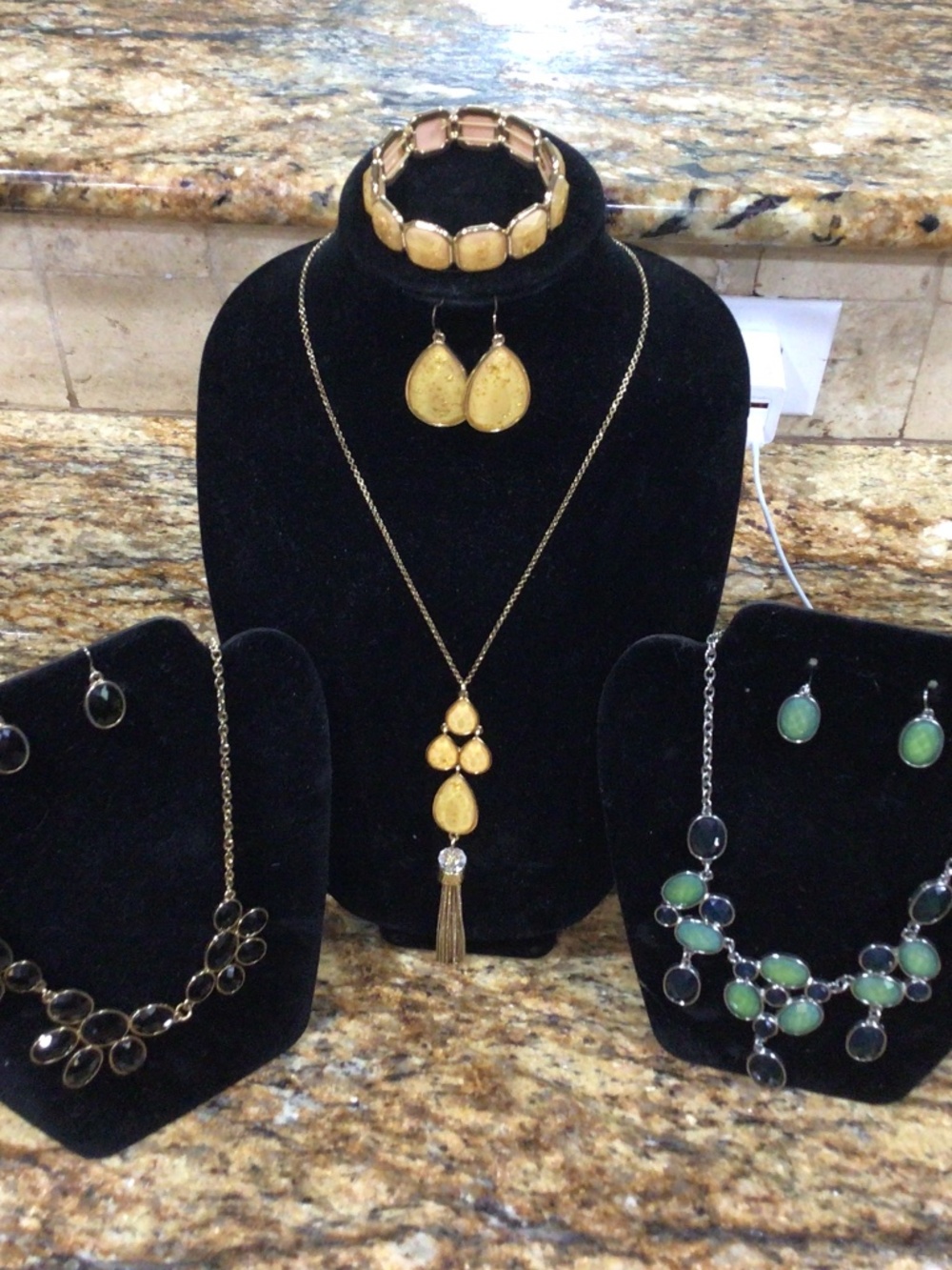 Lot of three necklace and earring sets. One with the bracelet.
